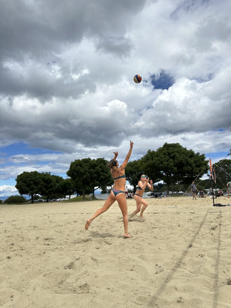 Beach volleyball player setting the ball during a match