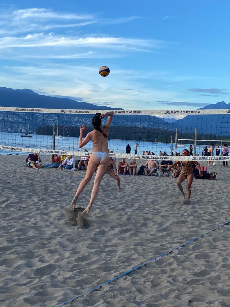 Beach volleyball player hitting the ball during a match