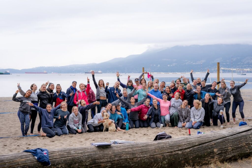 Group photo of players and participants at a KWVC beach volleyball event